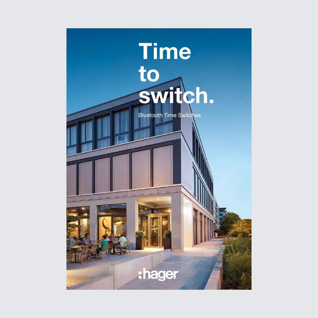 Advertisement for Bluetooth time switches by Hager with a modern building exterior at twilight