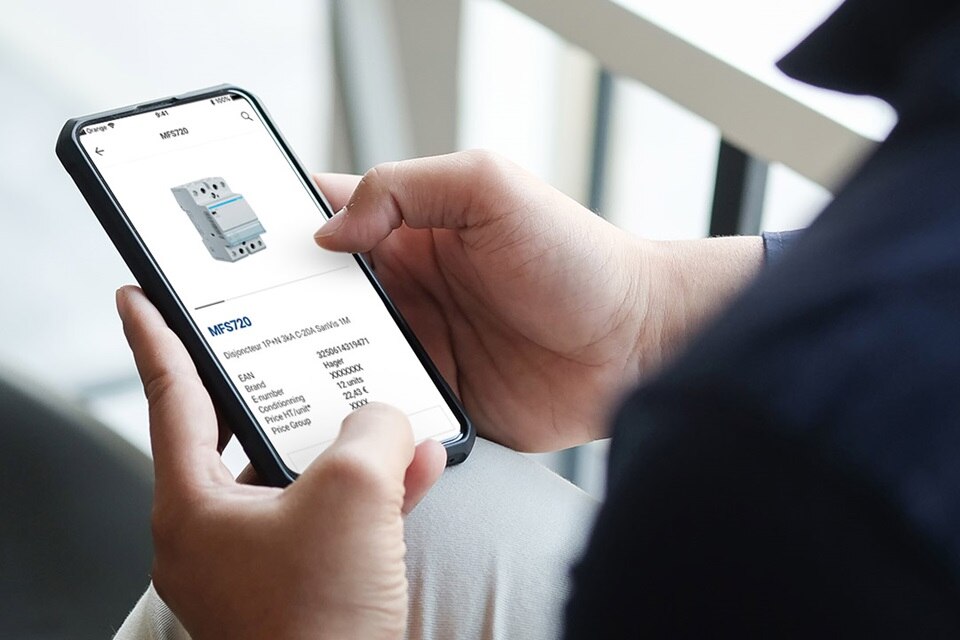 Person using a smartphone to view a circuit breaker product details on an application