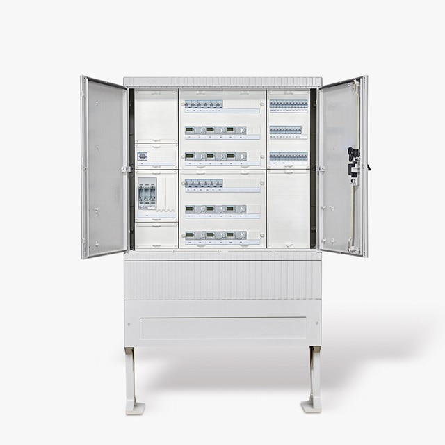 Elektroverteilertafel mit offenen Türen, die Sicherungsautomaten und Module in einer industriellen Umgebung zeigt