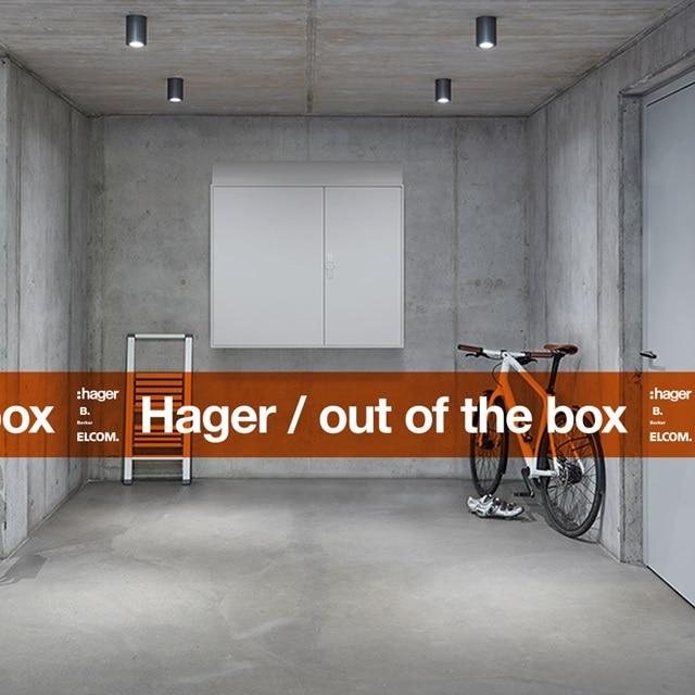 Modernes Betoninterieur mit Hager-Elektroverteilungsschrank, Fahrrad und Markenelementen
