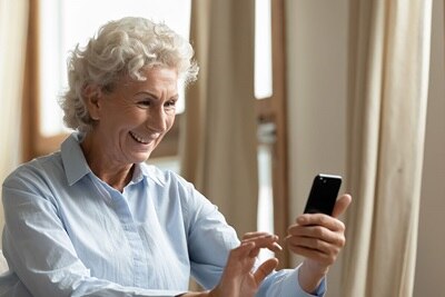 Eine Frau mit Handy in der Hand.