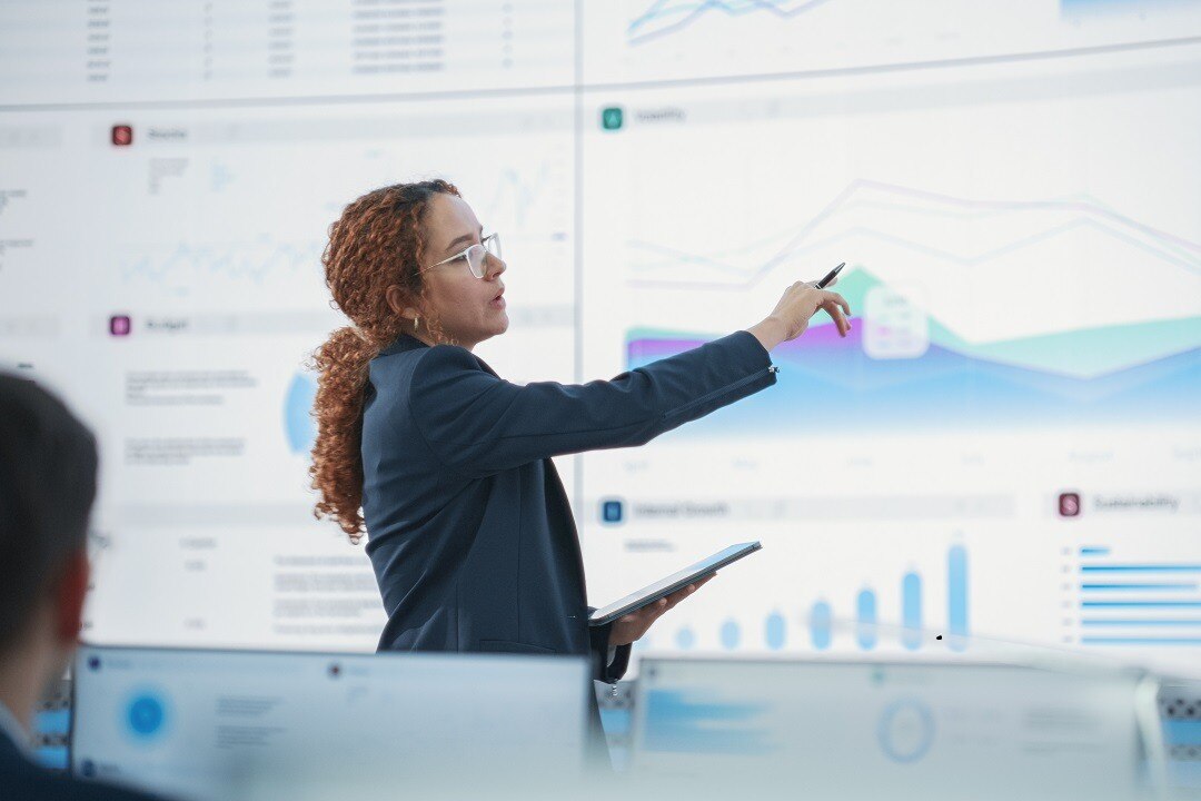 Female data scientist reviews report on digital screen