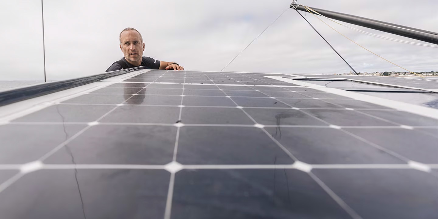 Fabrice Amedeo inspecting solar panels on a boat