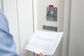 Hager Group Technician checks Hager control box