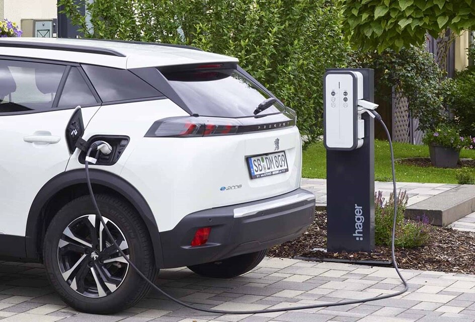 Electric car plugged into a Hager charging station in a residential setting