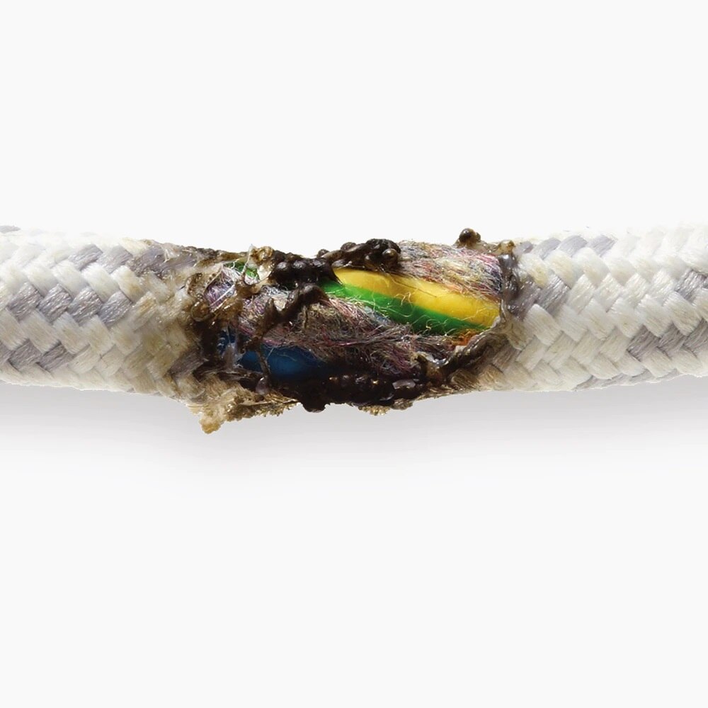 Damaged electrical cable with exposed and burnt wires