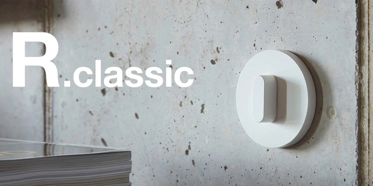 R.classic light switch design on a concrete wall