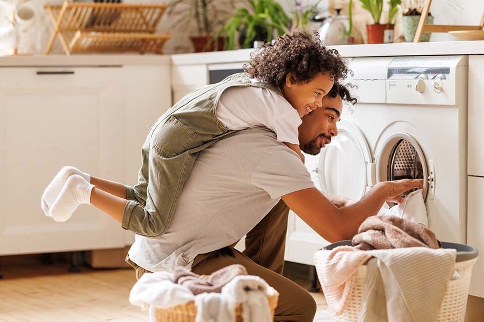 Father and son do laundry together
