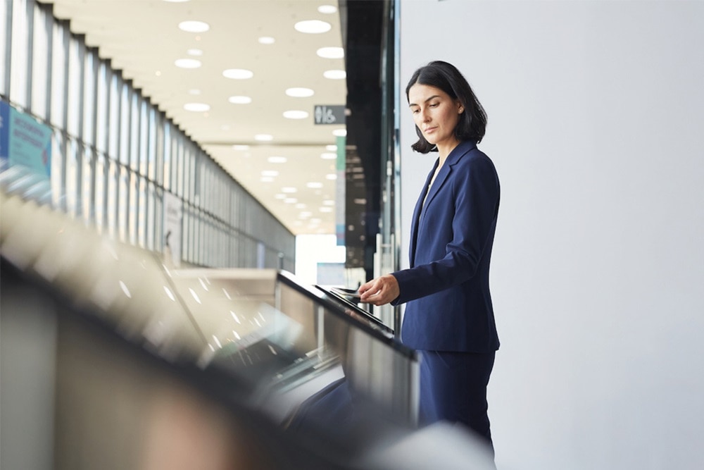 Businesswoman using smartphone at entrance control