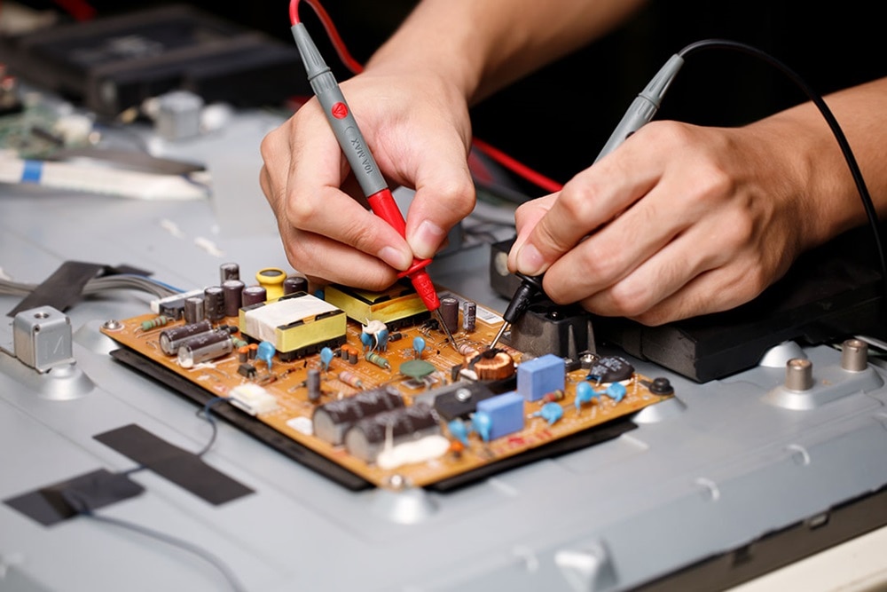 Person working on a soldering board