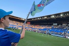 Hager Group fan waves a flag at the RCSA vs PSG match