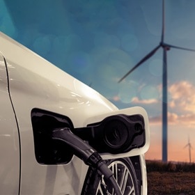 Hager Group Charging electrical car in front of the sunset