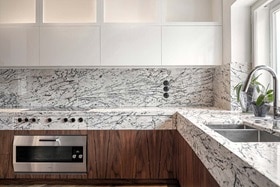 hager group modern kitchen with black and white marble design