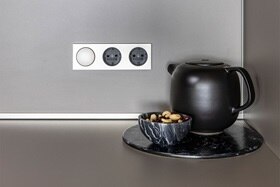 hager group teapot in front of berker sockets and switches