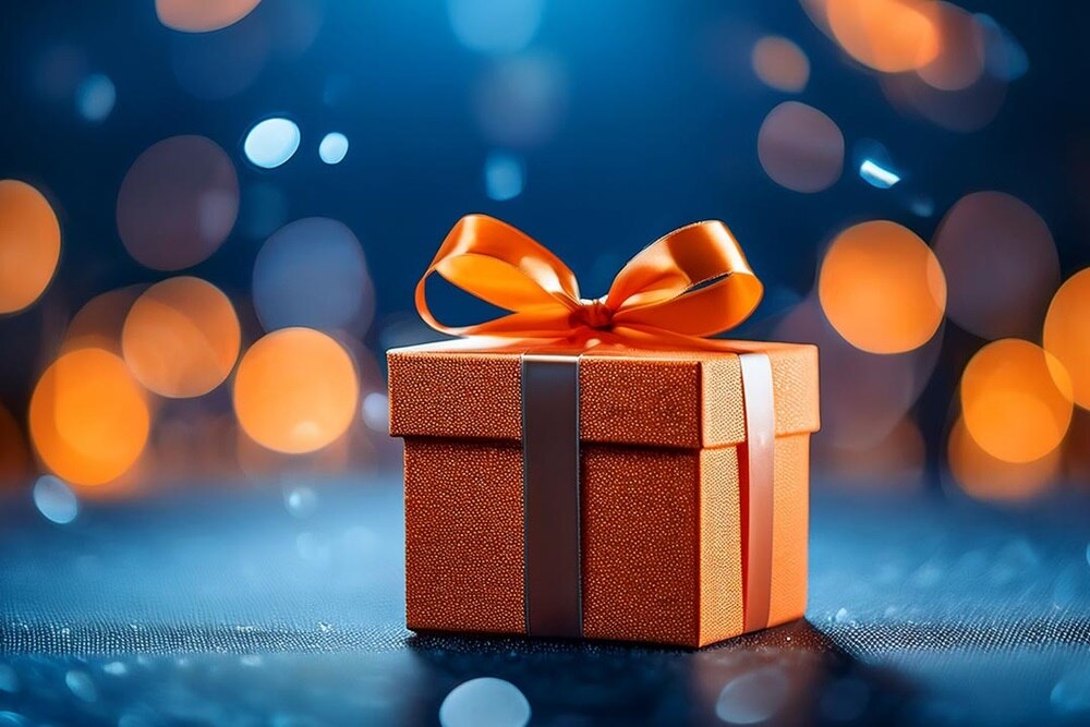 cadeau orange sur fond bleu avec des points lumineux orange 