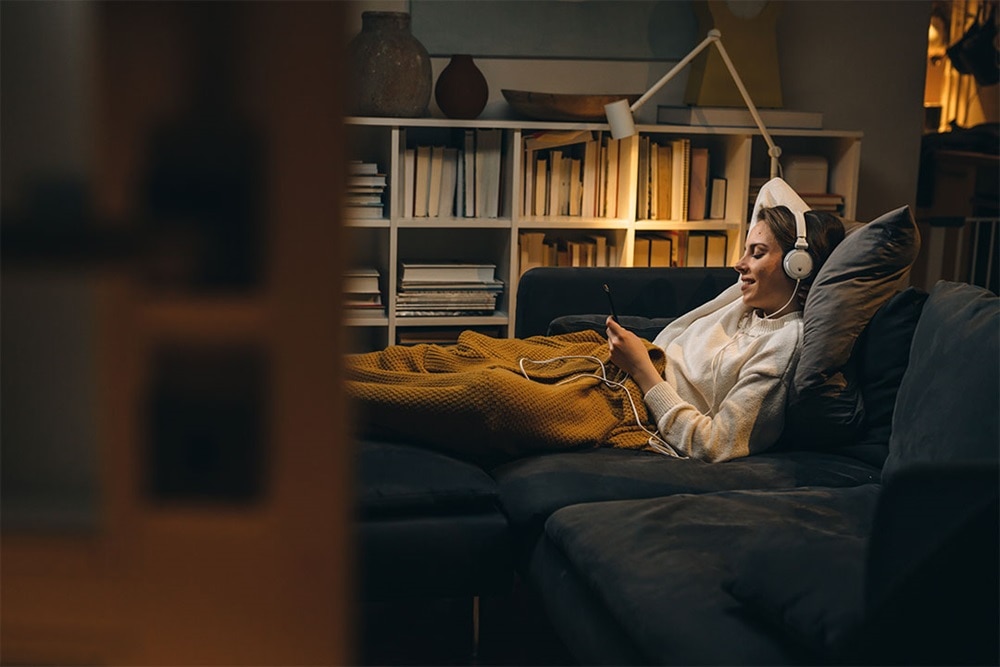 Young woman relaxing in the evening in a cozy atmosphere