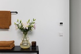 hager group vase with flowers in bathroom