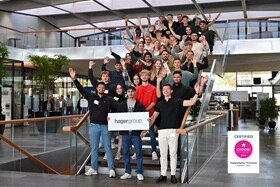 Hager Group interns and apprentices standing on stairs for getting the HappyIndex Trainees Award