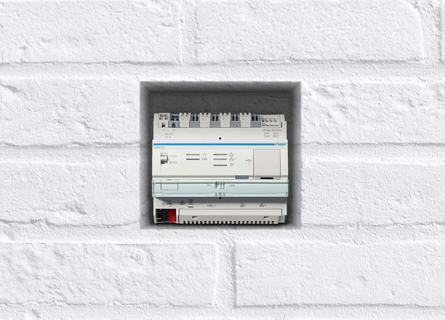 Tableau de distribution électrique de Hager installé dans un mur de briques blanches