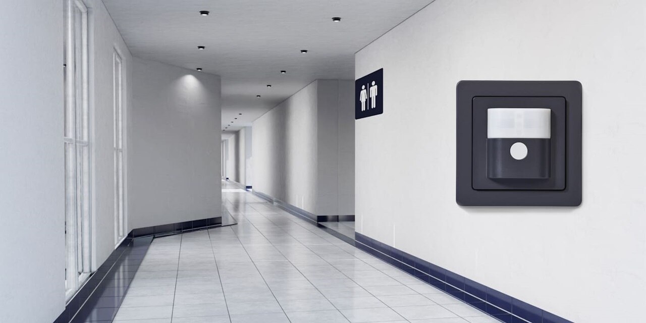 Vista di un ambiente interno di un corridoio in ambienti pubblici con sulla destra sensore di movimento, frontale, come riferimento per quel tipo di soluzione