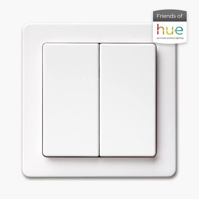 Vista frontale dell'interruttore della luce Berker Q.1 con bilanciere a 2 vie e cornice in bianco, accanto ad esso l'emblema Friends of Hue per la compatibilità con Philips Hue