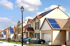 Esempio di ambiente applicativo di villette a schiera con tetti spioventi dotati di pannelli solari fotovoltaici, in un contesto residenziale soleggiato