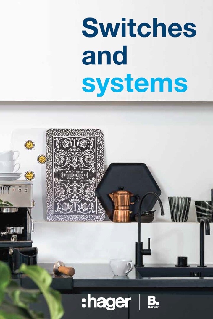 Modern kitchen interior with Hager wall switches and system solutions, espresso machine, and stylish black sink