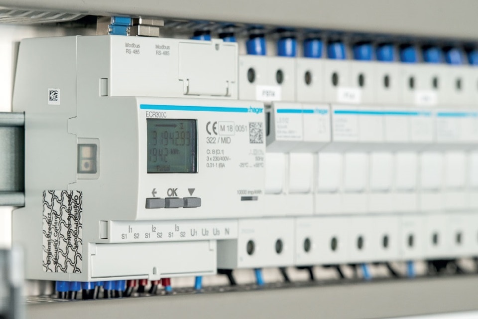 Hager brand energy meter and modular devices mounted on a DIN rail in an electrical distribution board