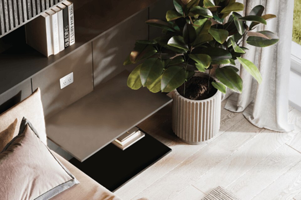 Modern living room interior with white electrical socket on wall, decorative plant, and stylish furniture