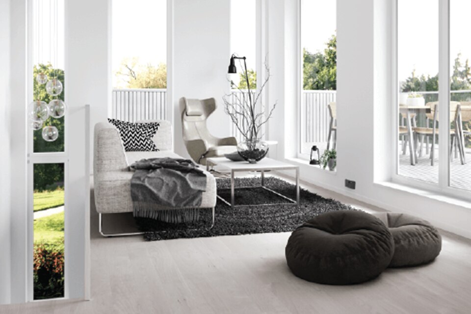 Modern living room interior with stylish furniture and large windows allowing natural light