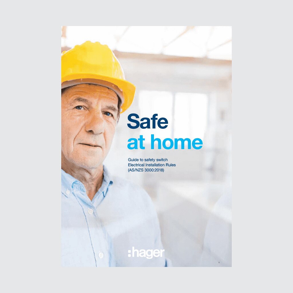 Person wearing a hard hat with 'Safe at home' guide for electrical safety by Hager