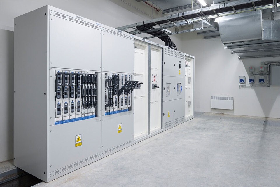 Pomieszczenie rozdzielni elektrycznej z panelami wysokiego napięcia i wyłącznikami obwodów w środowisku przemysłowym