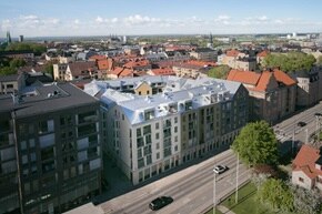 Flygbild över urbant landskap med byggnader som är utrustade med solpaneler på taken för hållbar energi