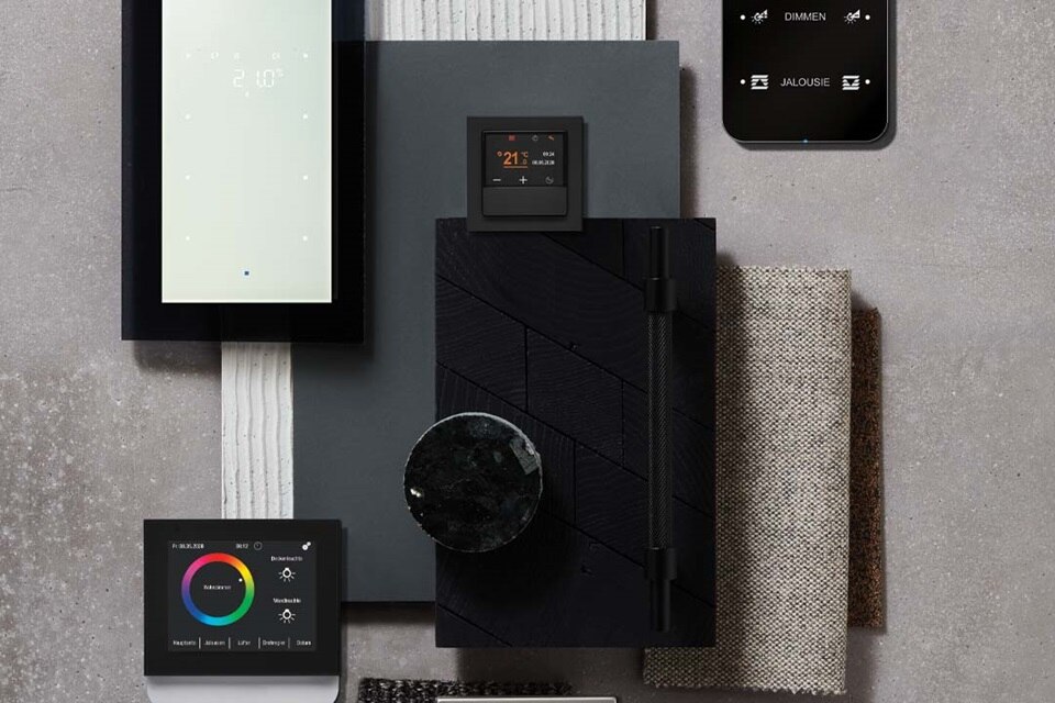 Smart home automation systems displayed on a table with various textures and materials, showcasing interface designs