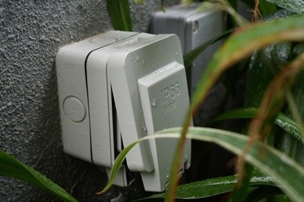 Hager outdoor socket on a gray wall  2