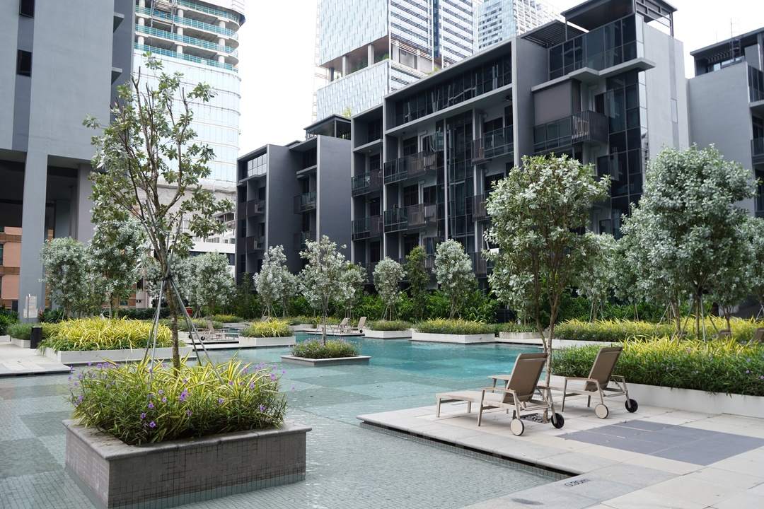 Modern residential complex with pool and greenery. 2